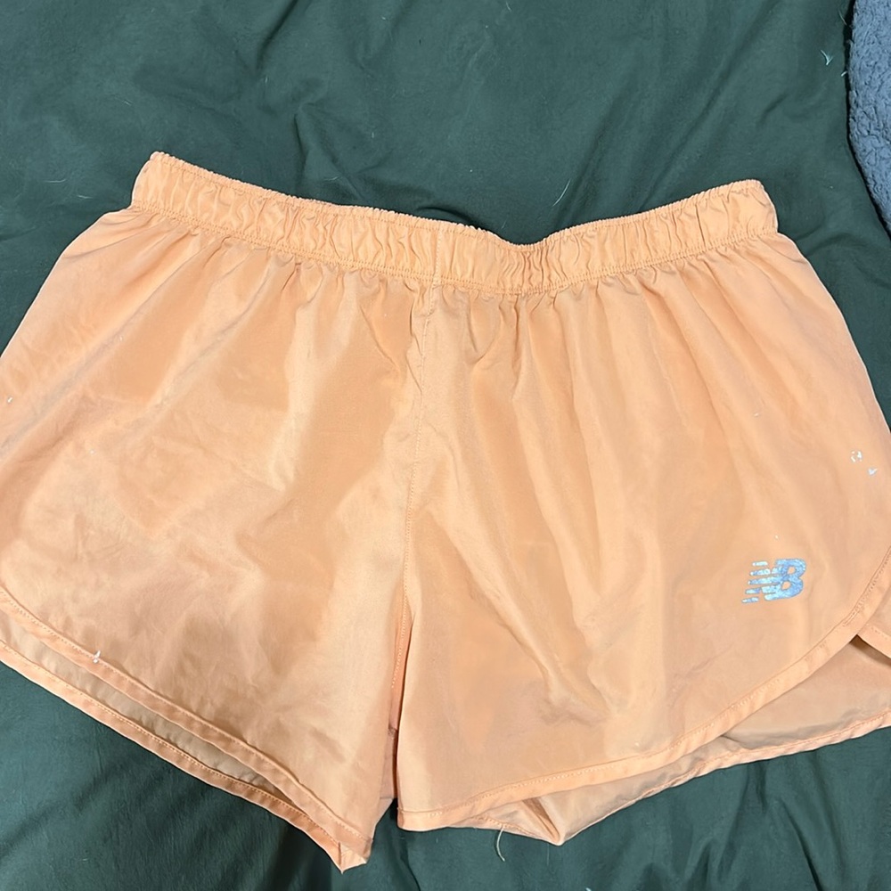Orange New Balance women’s running shorts